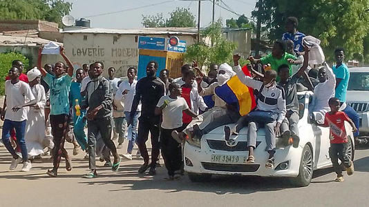 Chadians participate in an Anti-French protest in N'djamena, Chad, Friday, Dec. 6, 2024.