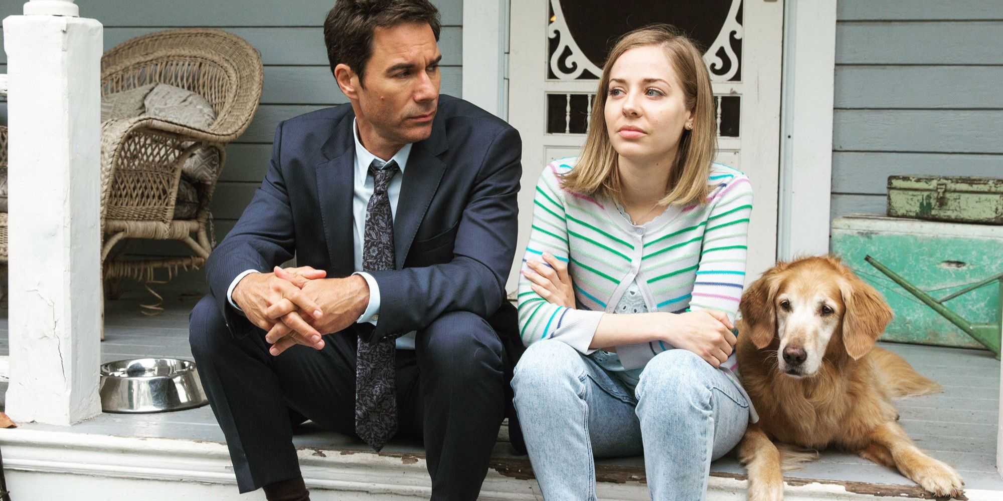 Grant McLaren and Marcy Warton sitting on porch steps with their dog in Travelers