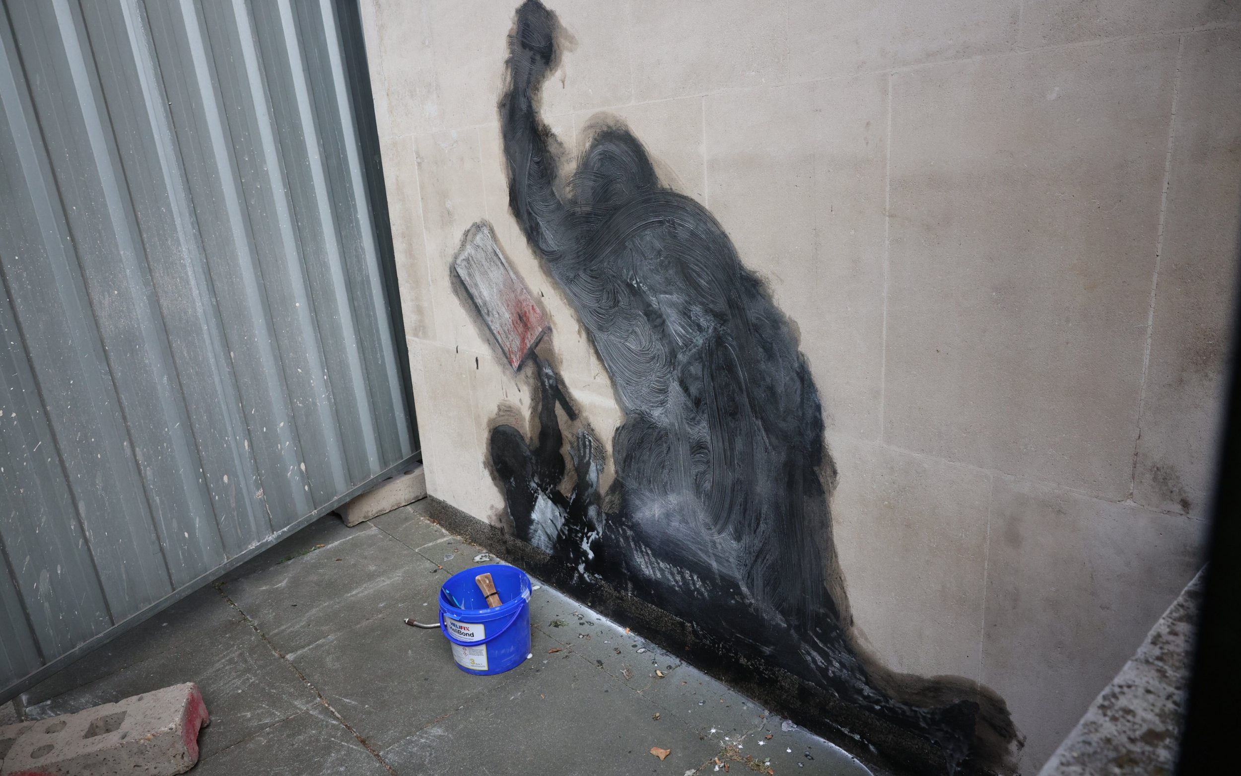 The artwork in the process of being scrubbed off with chemicals