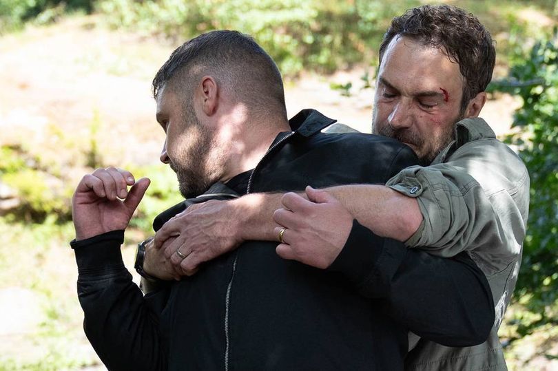 Emmerdale spoiler pictures show the moment John Sugden attacks Robert Sugden, before dragging his husband Aaron Dingle off of a cliff edge