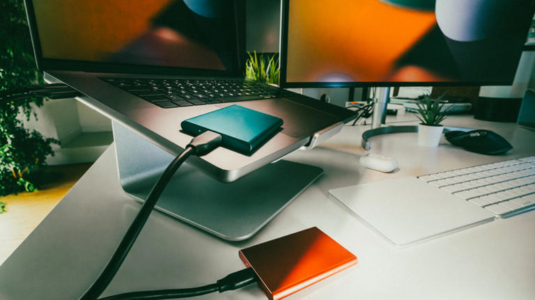 Two external drives connected to a laptop and monitor