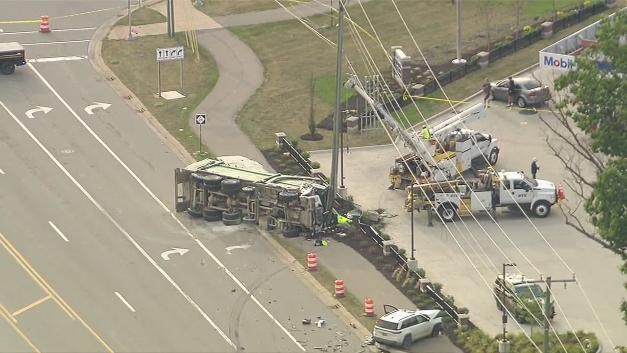 Lake Orion serious injury crash leaves garbage truck on its side, road