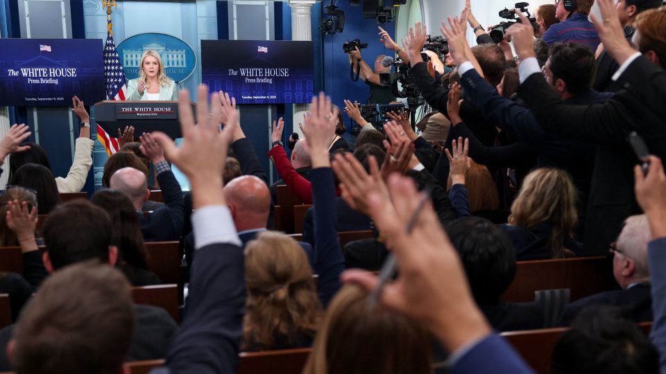 Journalists raise their hands to ask questions, as White House press secretary Karoline Leavitt speaks during a press briefing at the White House in Washington, DC, US, September 9, 2025. - Jonathan Ernst/Reuters