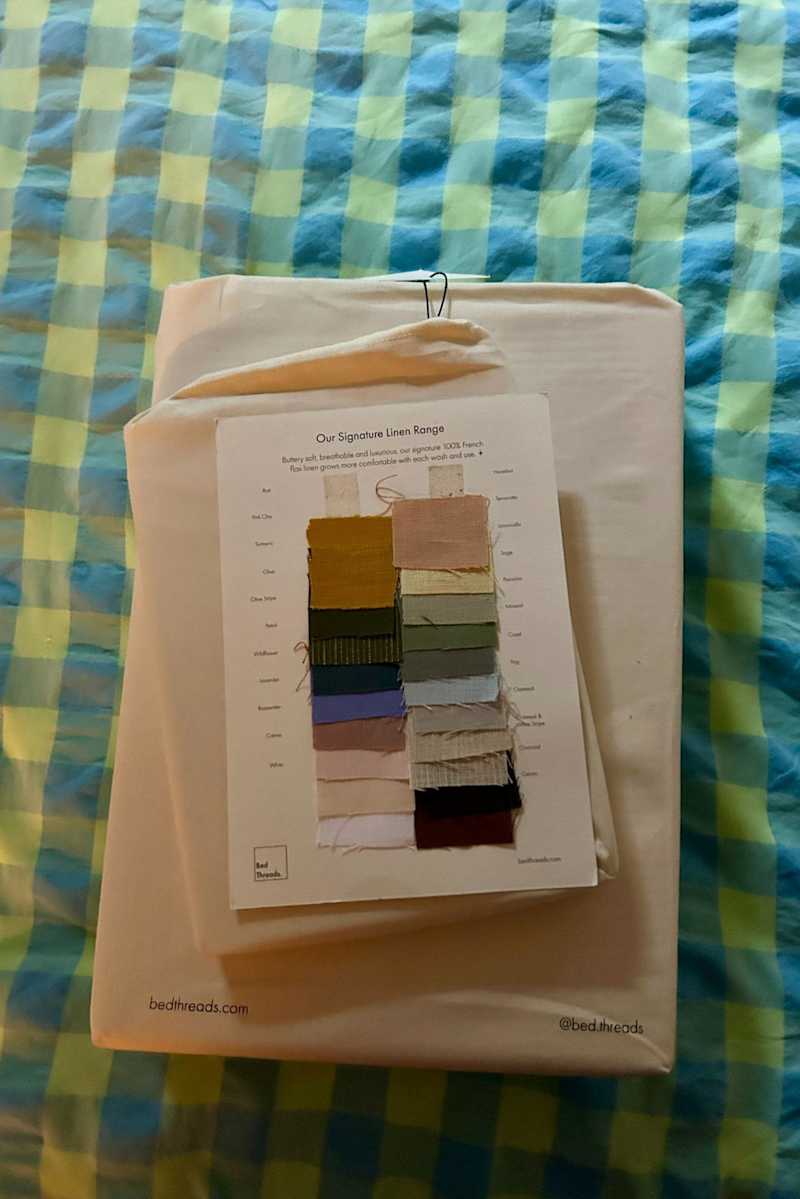 Linen fabric swatches displayed on a card from Bed Threads.