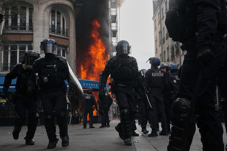 Riot police officers take position in front of a burning restaurant during the “Block Everything” protest movement in Paris, 10 September, 2025 AP Photo