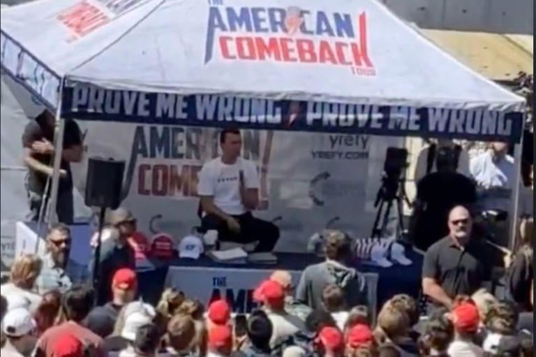 Charlie Kirk is pictured just before a sniper's bullet