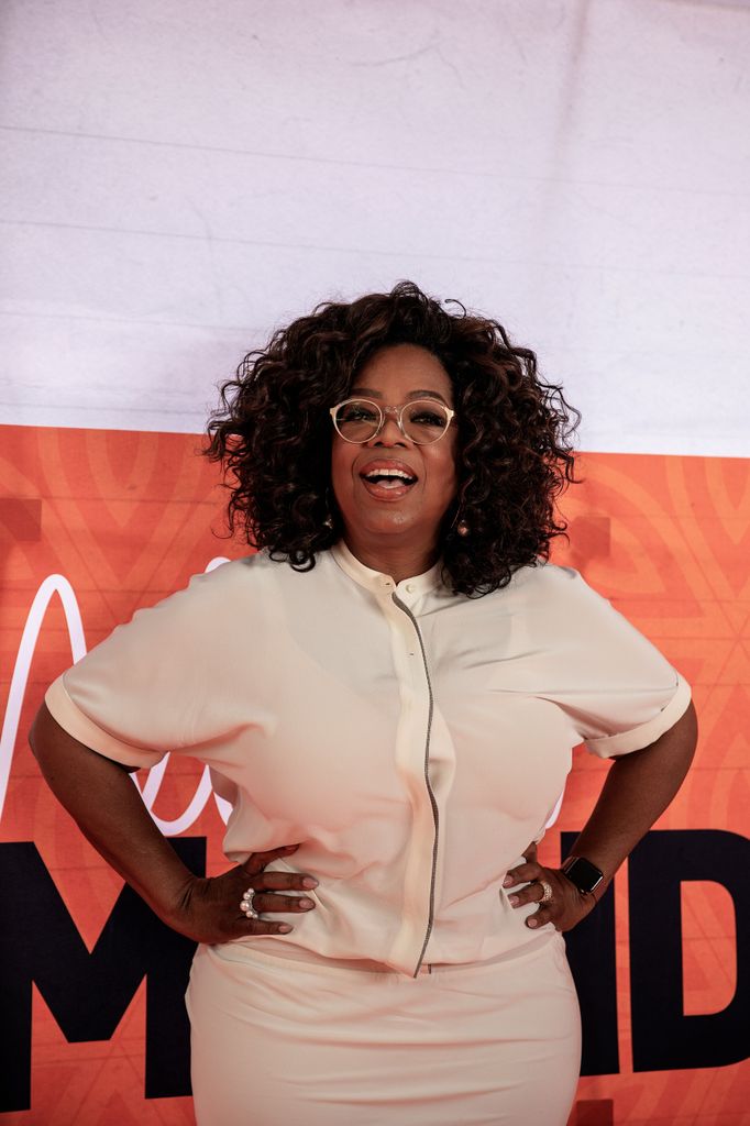 oprah winfrey beige outfit hands on hips