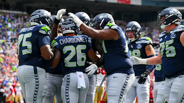 Sep 7, 2025; Seattle, Washington, USA; Seattle Seahawks running back Zach Charbonnet (26) celebrates with teammates after scoring a touchdown during the first half against San Francisco 49ers at Lumen Field. | Steven Bisig-Imagn Images