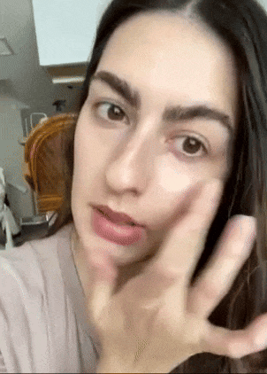 Person applying skincare product to face, gently massaging it in circular motions. Ideal for a shopping article on beauty and skincare products