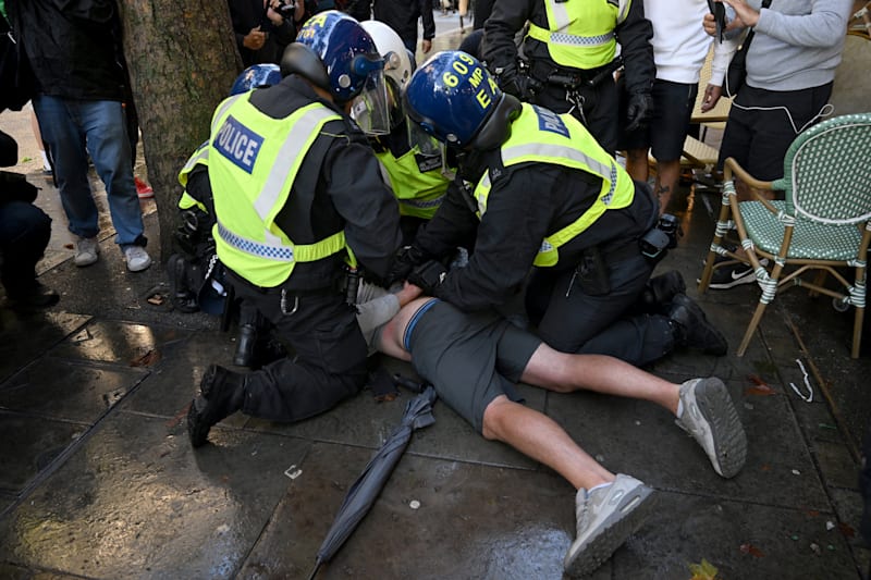 Police officers hold down a supporter of British anti-immigration activist Stephen Yaxley-Lennon, also known as Tommy Robinson, during a demonstration, in London, Britain, September 13,, 2025. REUTERS/Jaimi Joy