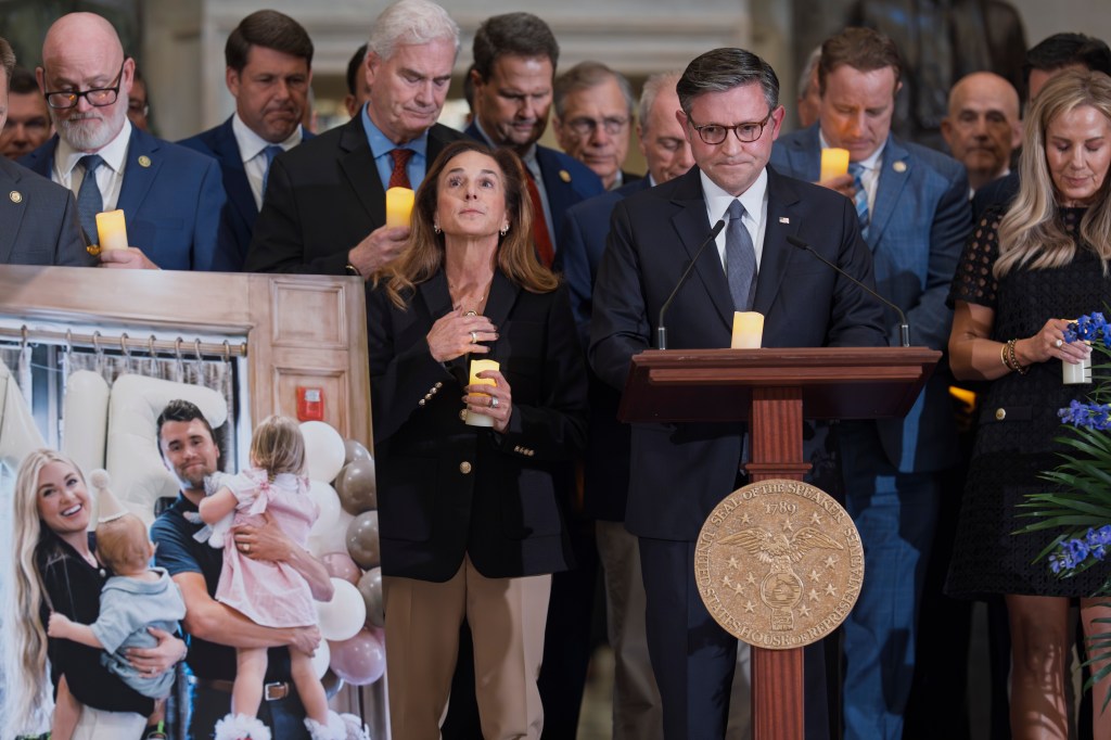 Speaker of the House Mike Johnson, R-La., joined at left by Rep. Lisa McClain, R-Mich., leads a memorial vigil to honor conservative activist Charlie Kirk. AP