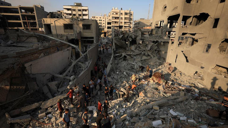 Palestinians inspect the damage at the site of Israeli strikes that destroyed Al-Jundi al-Majhoul residential tower on Sunday, in Gaza City, September 15, 2025. - Dawoud Abu Alkas/Reuters