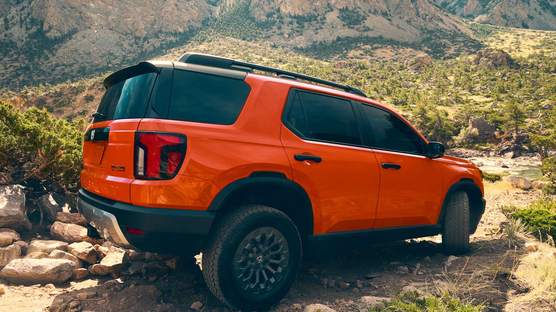 2026 Honda Passport in orange driving off-road