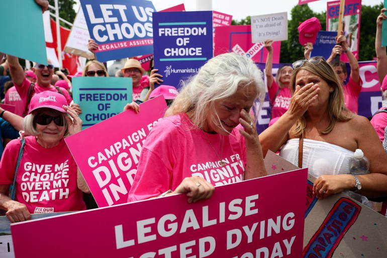 Protesters react after the UK Parliament votes in favour of a bill to legalise assisted dying in London on June 20, 2025 [Isabel Infantes/Reuters]