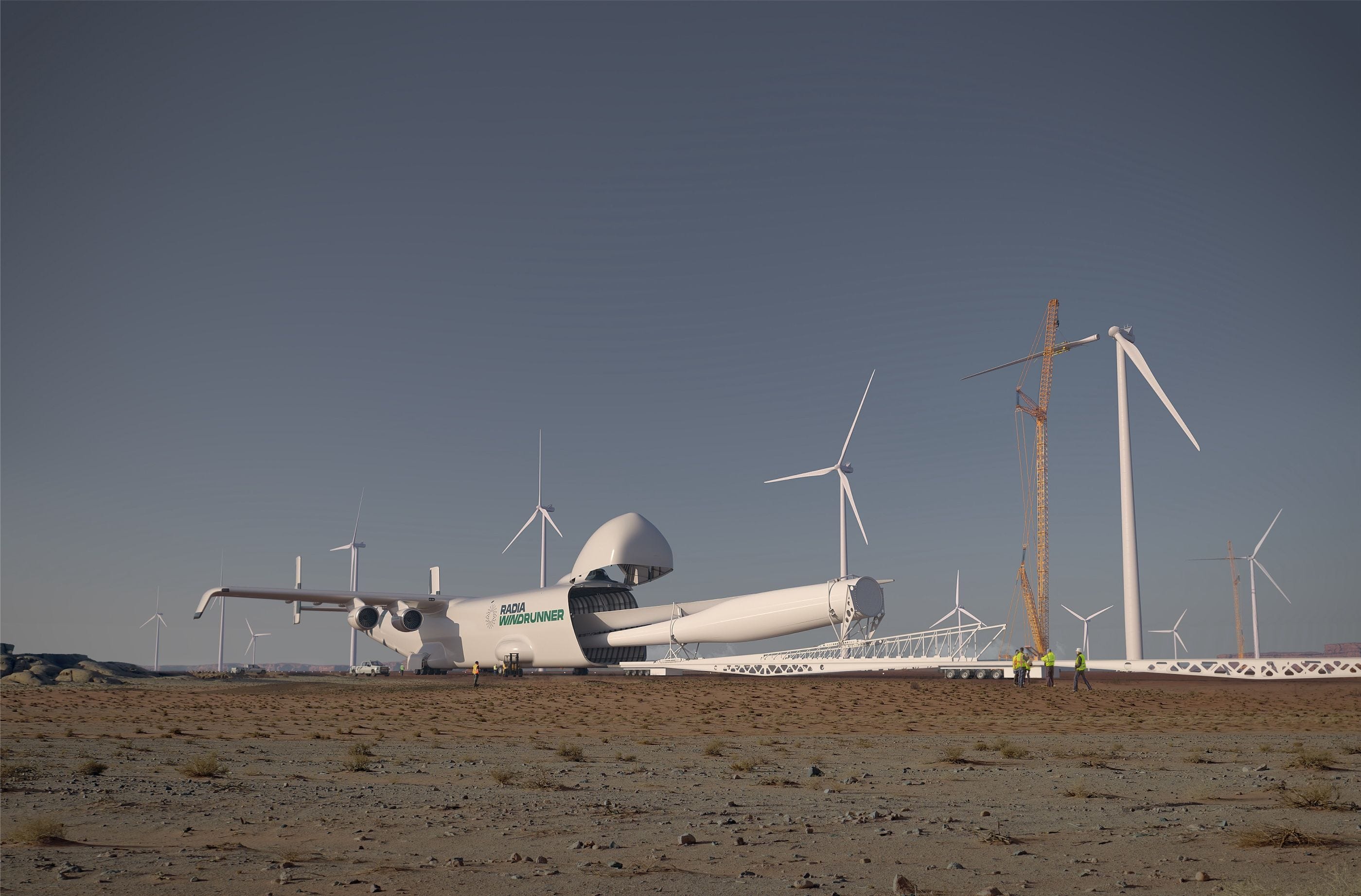The Radia WindRunner in a field surrounded by wind turbines. It is unloading a giant turbine.