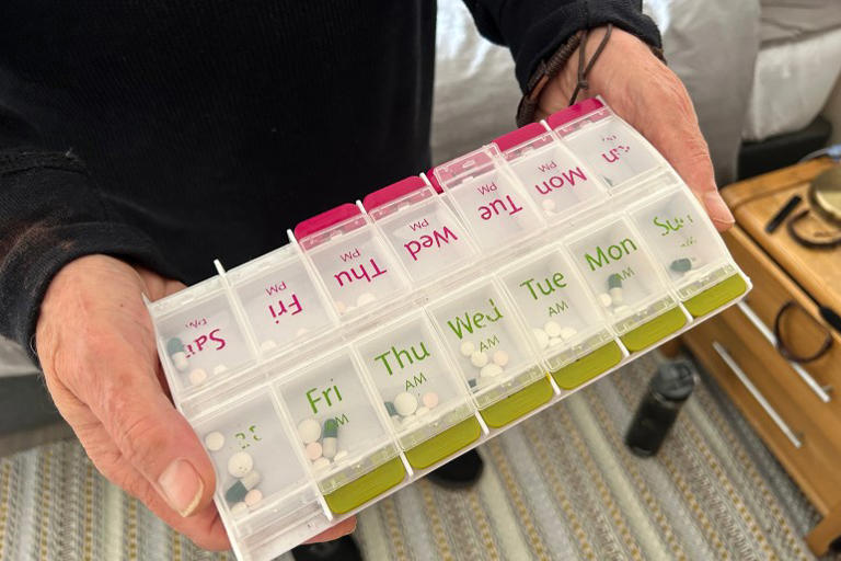 A pill box contains a week of Pandolfo’s medications [Amandas Ong/Al Jazeera]