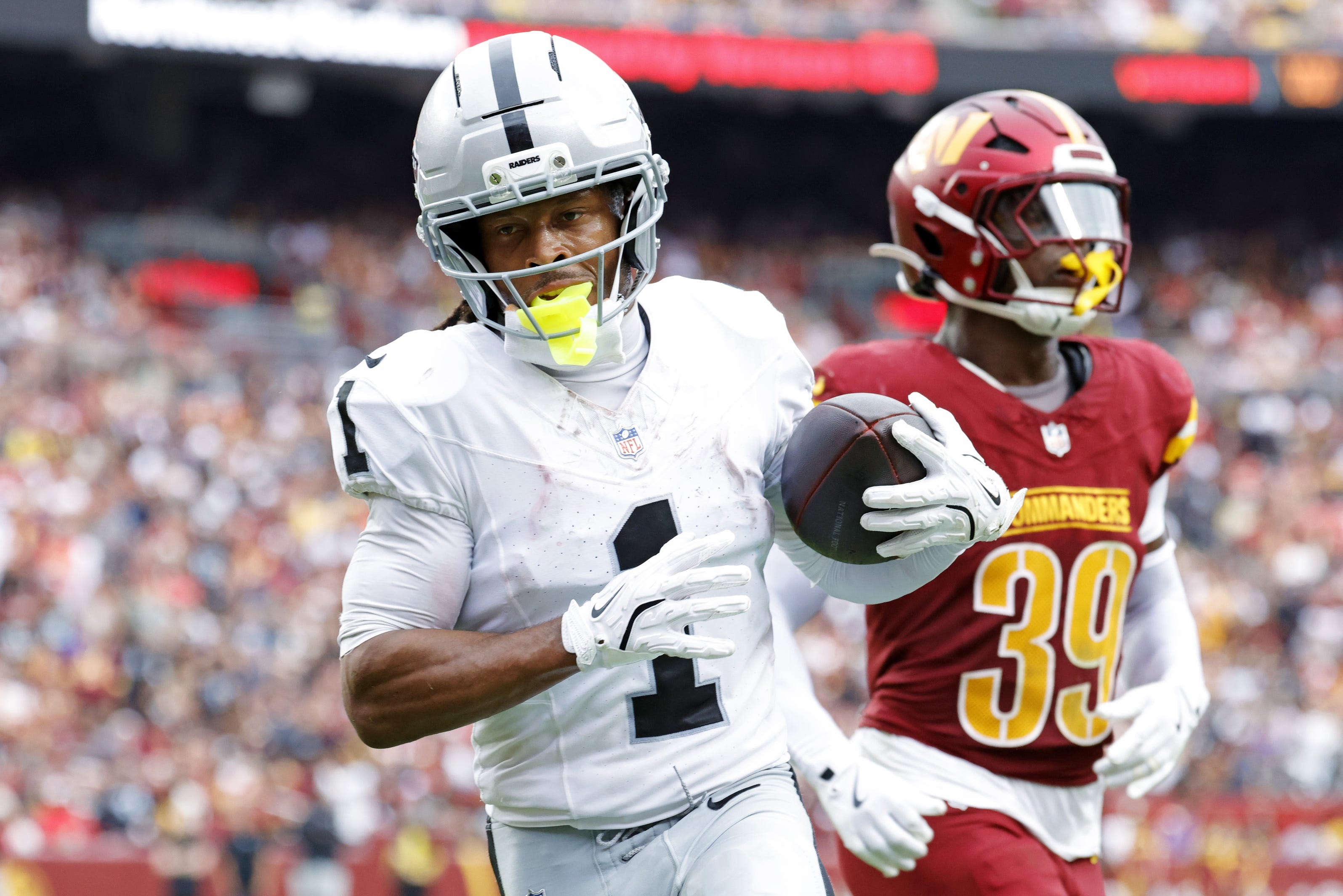 Sep 21, 2025; Landover, Maryland, USA; Las Vegas Raiders wide receiver Tre Tucker (1) celebrates after scoring a touchdown during the second half against the Washington Commanders at Northwest Stadium. Mandatory Credit: Amber Searls-Imagn Images
