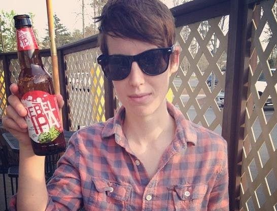 A younger Herzog, holding a Rebel IPA drink