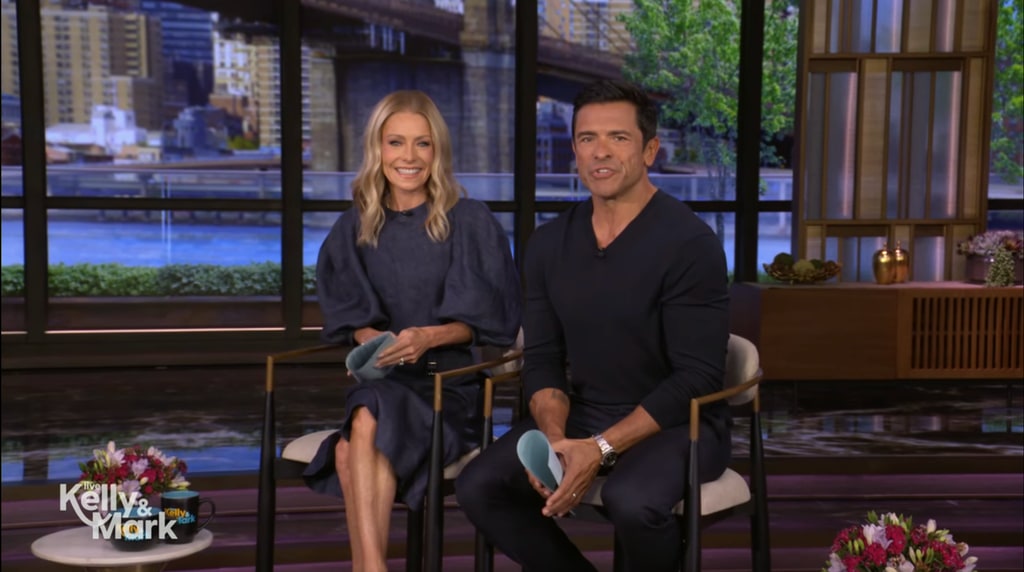 Kelly in navy dress and Mark in sweater sat in LIVE studio