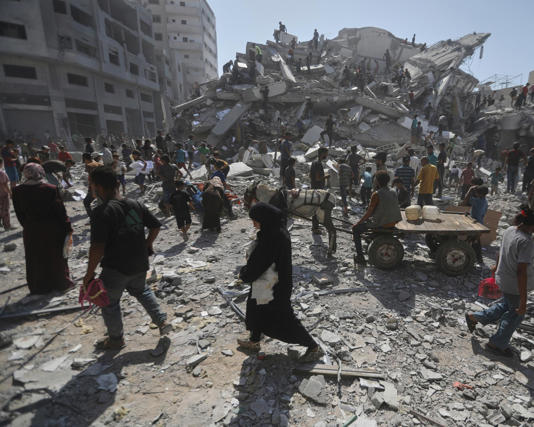 Palestinians amid the rubble of Gaza City last month. Humanitarian officials say Hamas still has a strong presence there. Photograph: Yousef Al Zanoun/AP