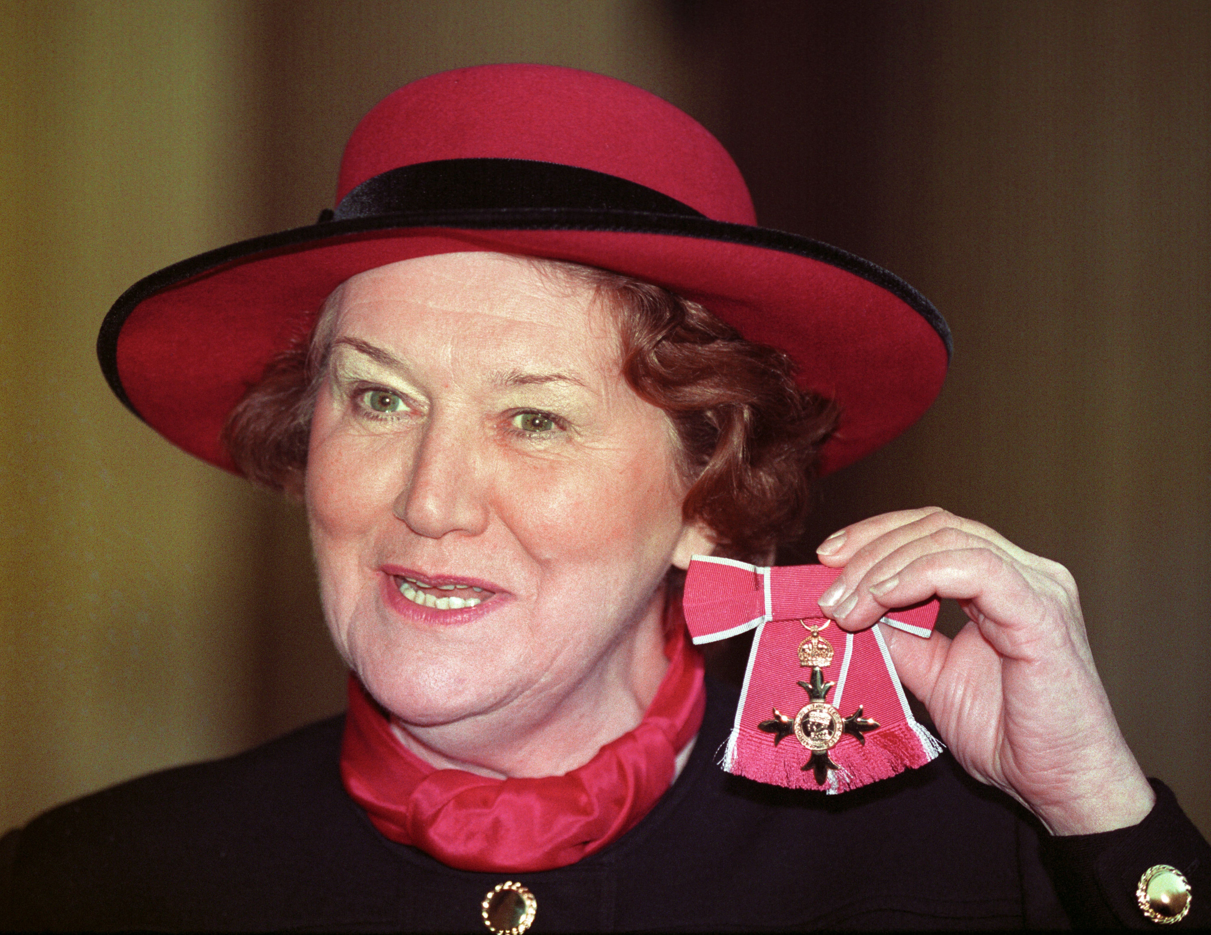 Patricia Routledge at Buckingham Palace in 1993 after receiving her OBE from the Queen (PA)