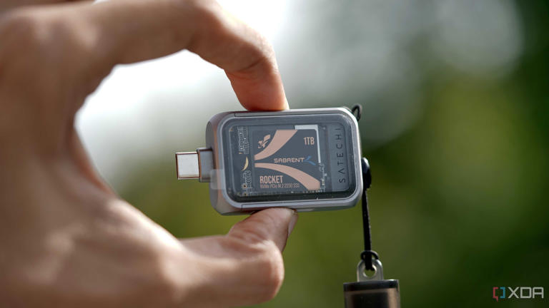 Fully assembled 2230 NVMe SSD enclosure against a green blurry background