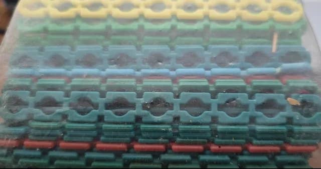 Rows of interlocking hexagon shapes arranged in layers within a clear container