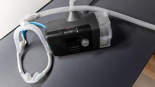 CPAP machine on black surface.