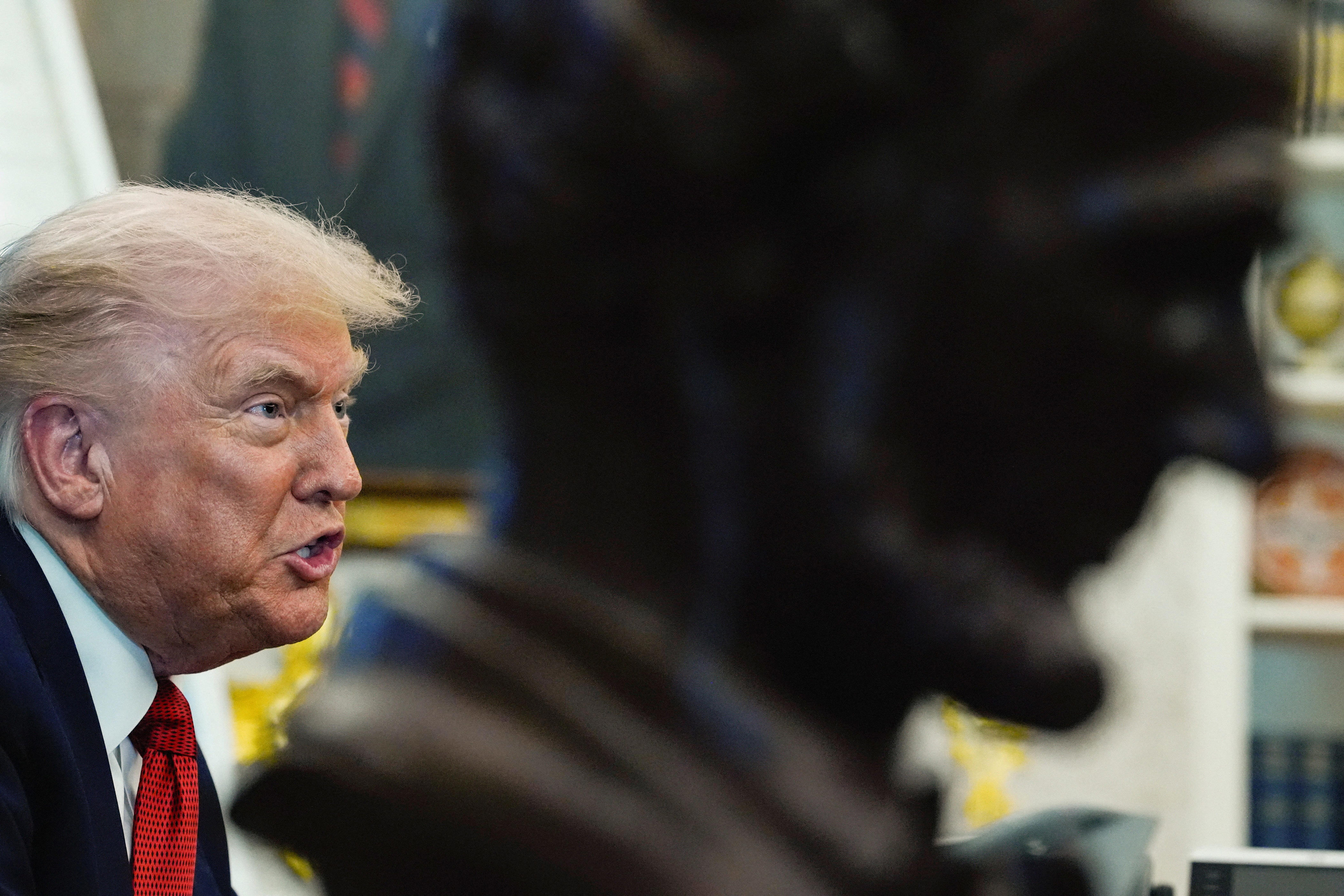 President Donald Trump, behind a bust of former President Abraham Lincoln, attends an event to sign an executive order authorizing the construction of an access road to the Ambler mining district in Alaska, at the White House, in Washington, D.C., on Oct. 6, 2025.