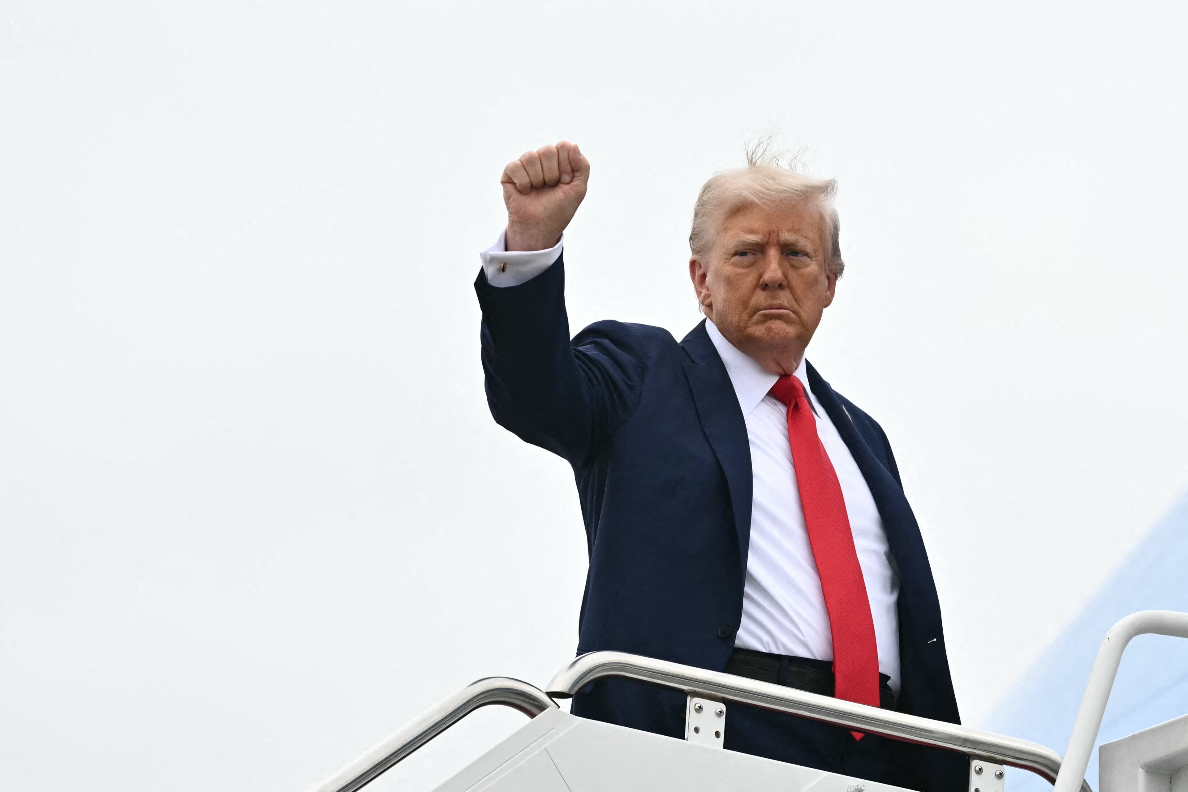 US President Donald Trump raises a fist as he makes his way to board Air Force One before departing from Joint Base Andrews in Maryland on September 21, 2025. Trump is heading to Glendale, Arizona to attend the public memorial service for Charlie Kirk. (Photo by Mandel NGAN / AFP) (Photo by MANDEL NGAN/AFP via Getty Images)      (Photo: MANDEL NGAN via Getty Images)