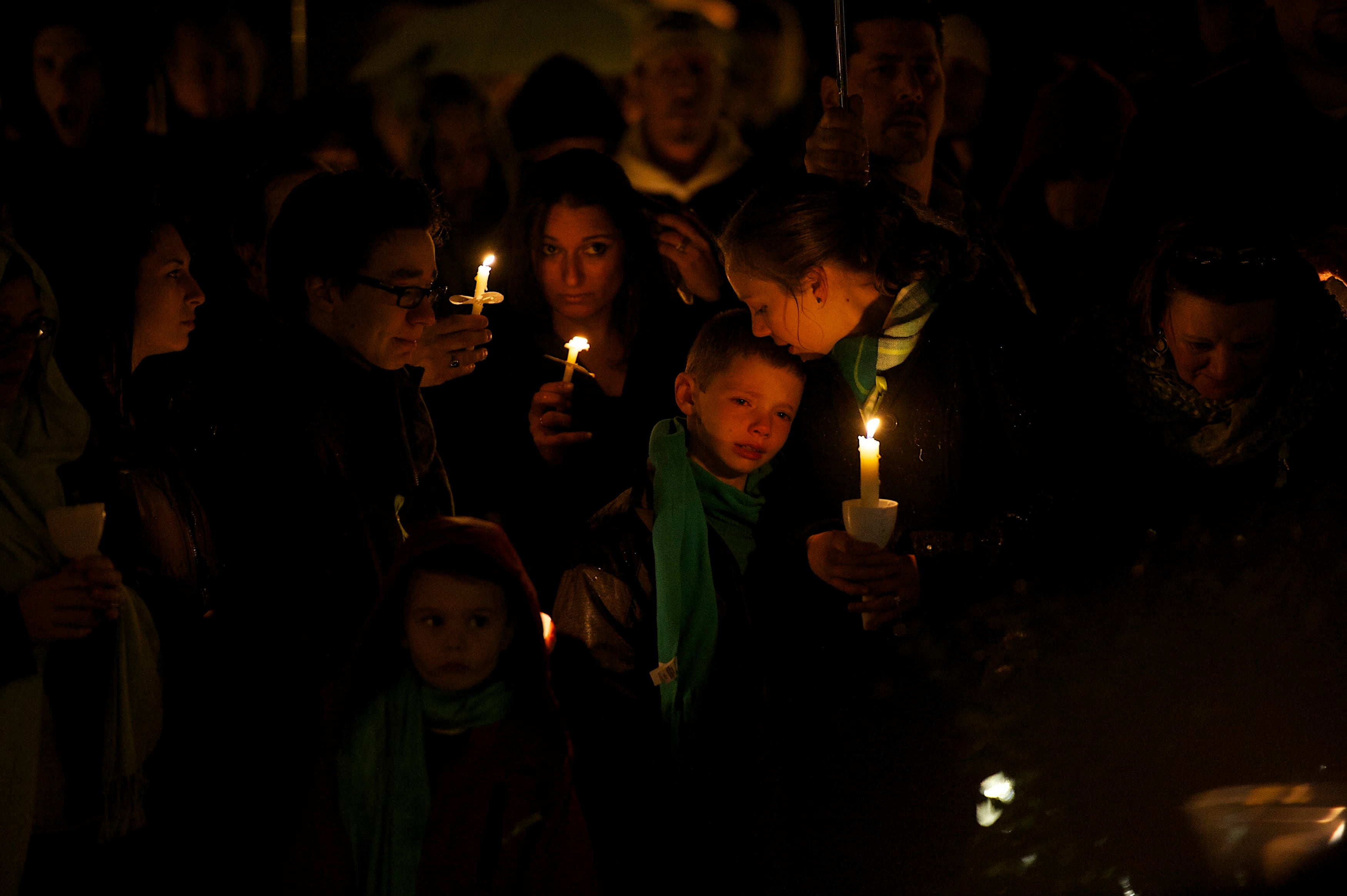 Family members gather for a candlelight vigil in honor of Sandy Hook Principal Dawn Hochsprung in December 2012. / Mark Makela / Corbis via Getty Images
