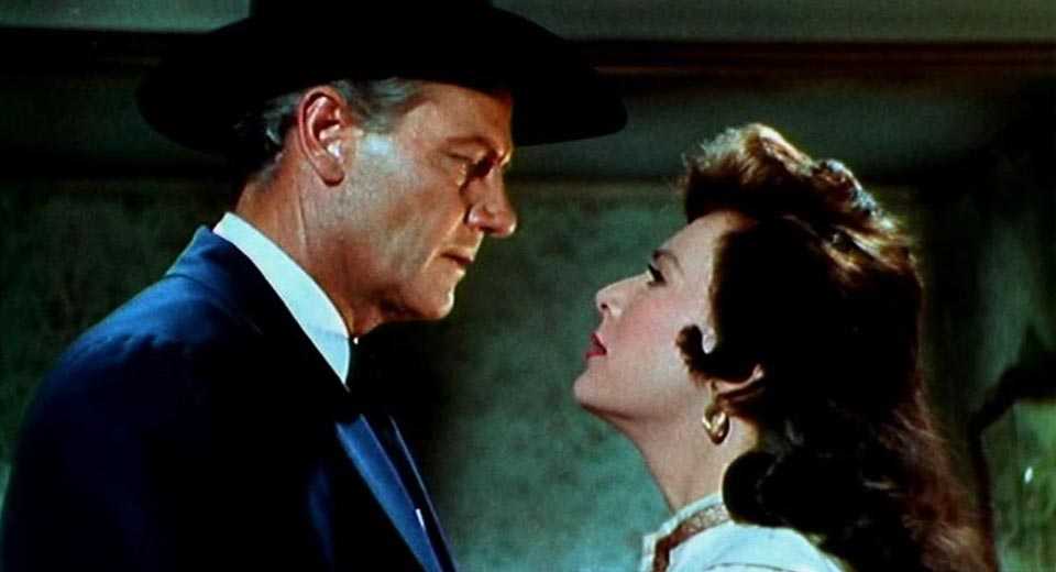 A man and woman talk closely in Stranger on Horseback
