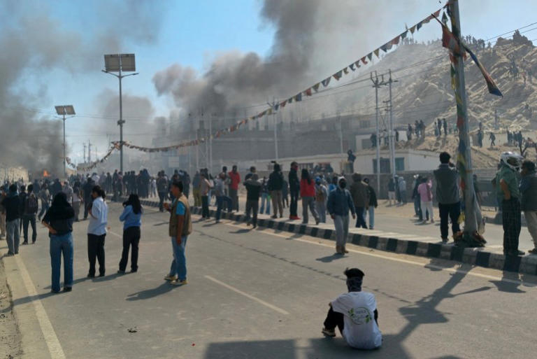 Smoke rises from a police vehicle that was torched by the demonstrators near the Bharatiya Janata Party (BJP) office in Leh on September 24, 2025. Indian police clashed with hundreds of protesters demanding greater autonomy in the Himalayan territory of Ladakh, leaving several people injured, authorities said [Tsewang Rigzin /AFP]