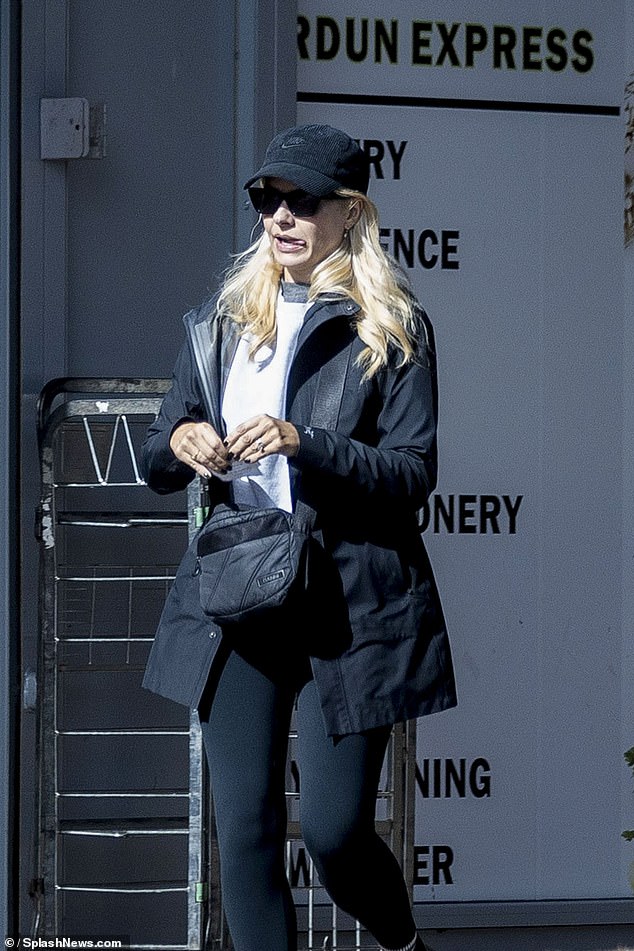 Holly opted for a laid back look for the day, wrapping up in a black jacket which she wore with matching leggings and boots