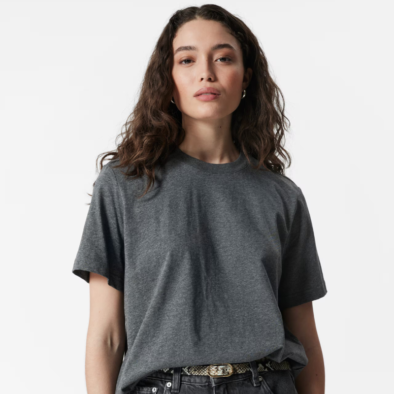 A woman wears a grey t-shirt