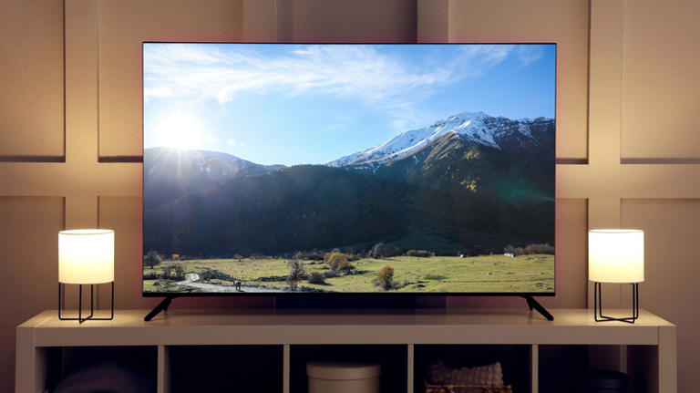 Picture of a TV displaying a bright mountain scene