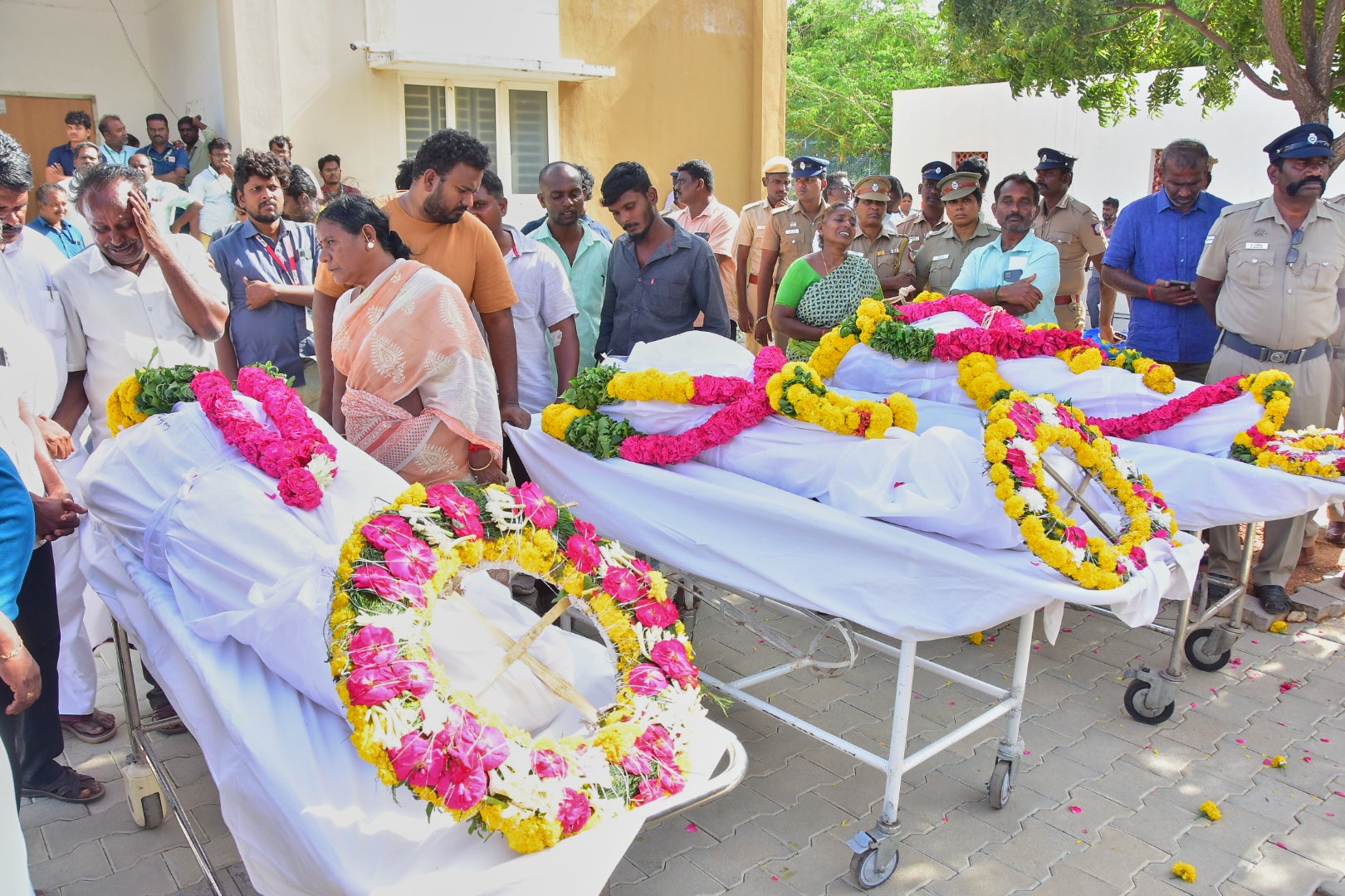 Relatives of people killed in the Karur stampede mourn as they take the bodies from a hospital (AP)