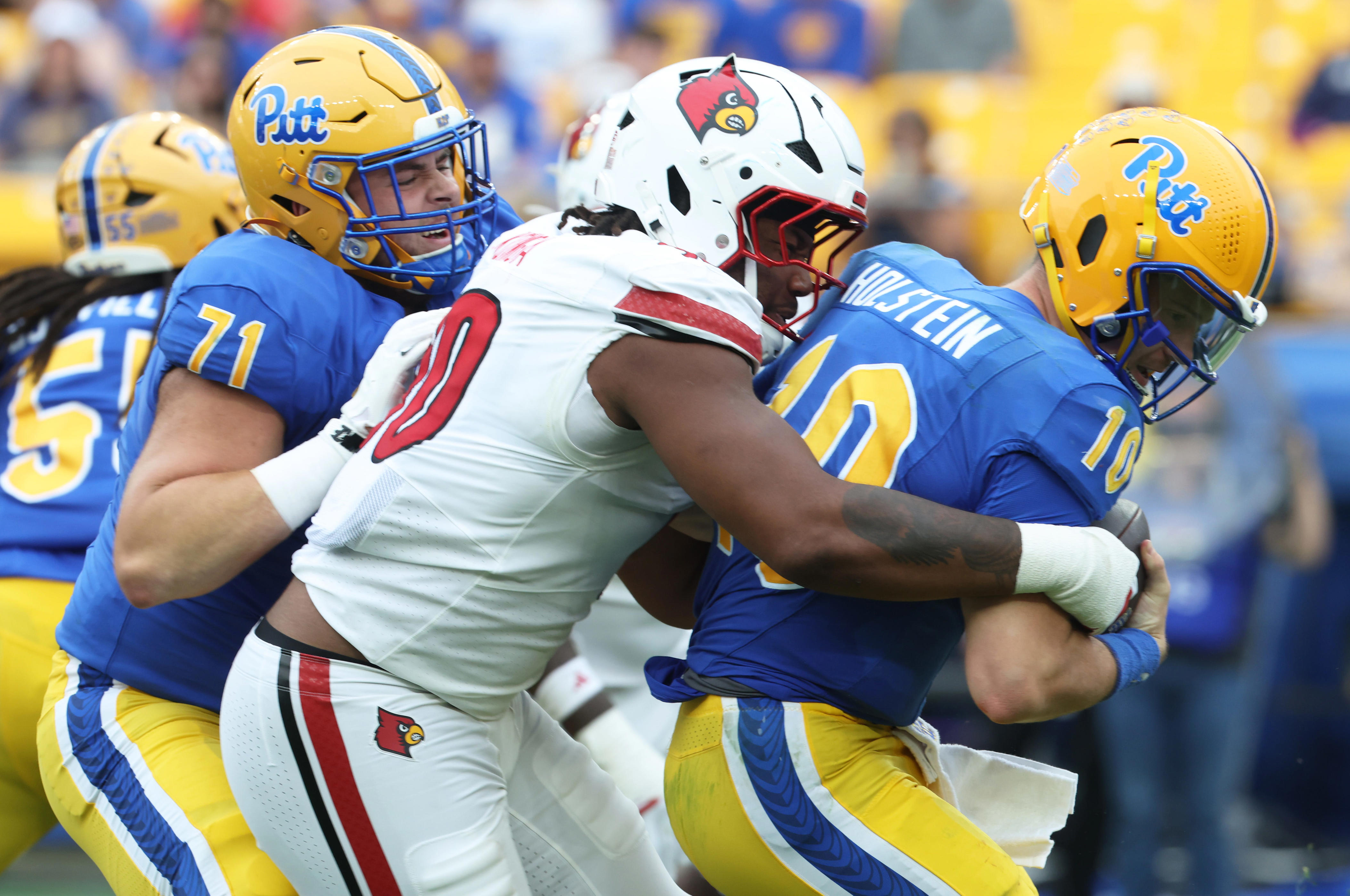 Sep 27, 2025; Pittsburgh, Pennsylvania, USA; Louisville Cardinals defensive lineman Rene Konga (90) sacks Pittsburgh Panthers quarterback Eli Holstein (10) during the fourth quarter at Acrisure Stadium. Mandatory Credit: Charles LeClaire-Imagn Images
