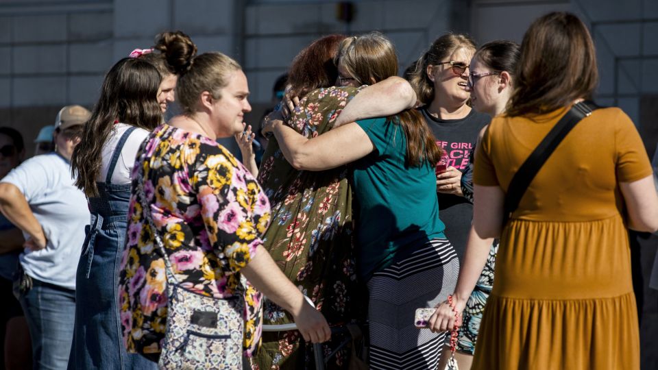 Church members and residents reunite at Trillium Theater located across the street from the site of a shooting and fire at the Church of Jesus Christ of Latter-day Saints in Grand Blanc, Michigan, on September 28, 2025. - Emily Elconin/Getty Images