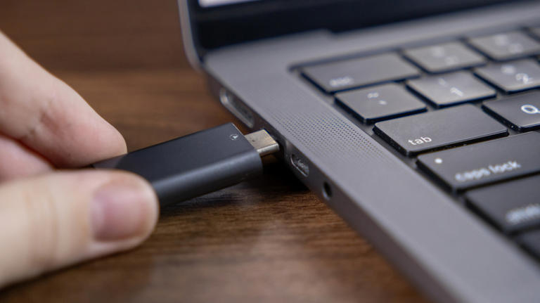 close up of someone plugging USB