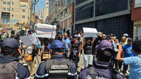 Demonstrators hold up placards in Antananarivo, Madagascar, Thursday, Sept. 25, 2025.