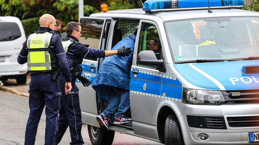 A teenager was seen being put into a police van. Pic: AP