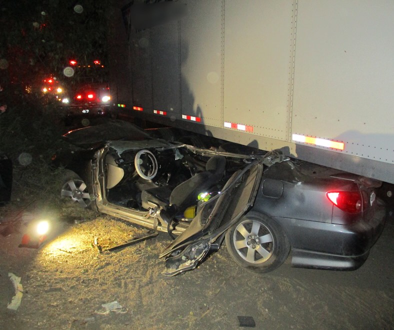 2 injured after car gets lodged under trailer in Madera County crash