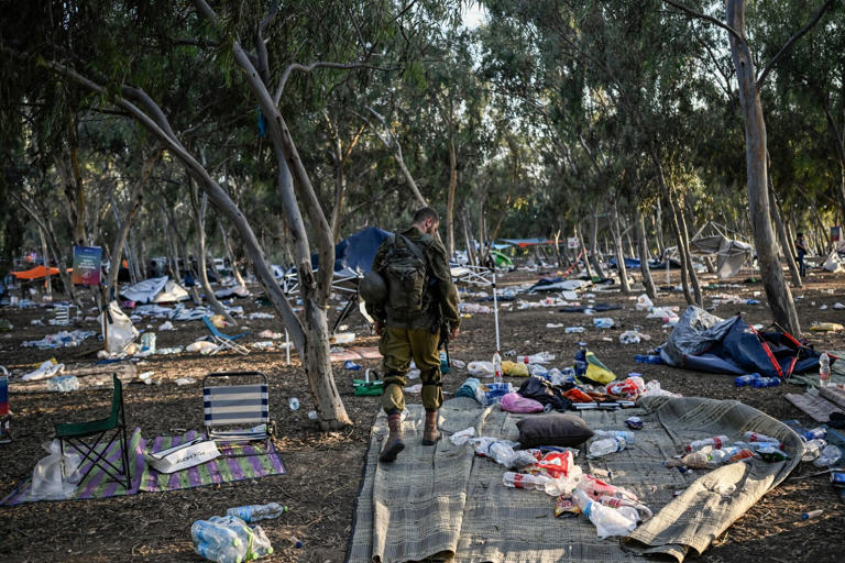 An Israeli soldier patrols near the site of the Hamas attack on a music festival in southern Israel on Oct. 12.