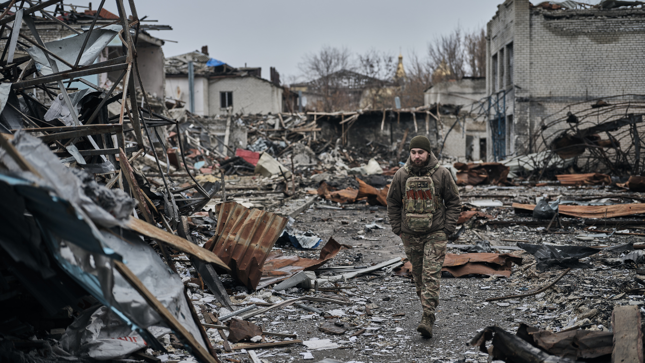 A soldier walking in a destroyed Ukrainian city