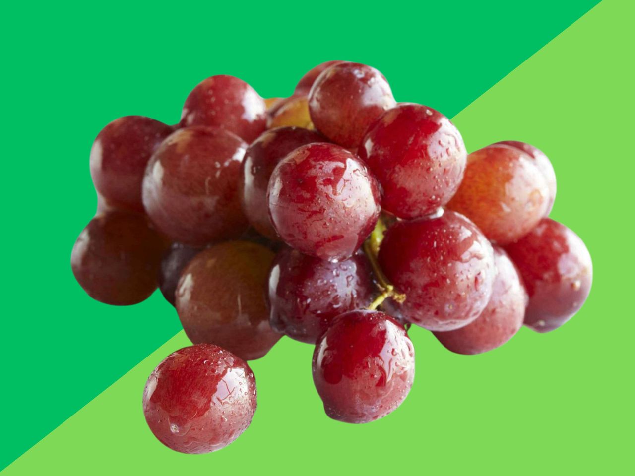 wet red grapes on a green background