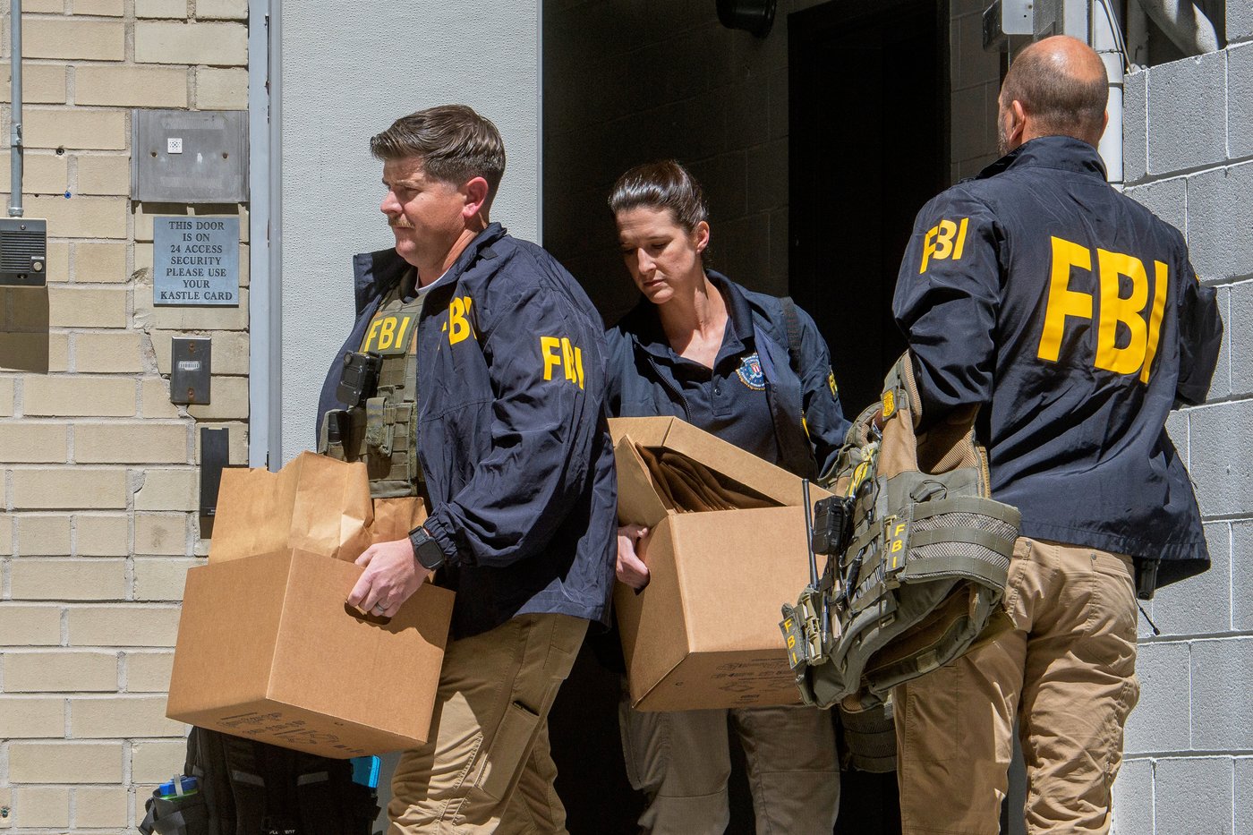 FILE - FBI agents carry boxes from former National Security Advisor John Bolton's office in Washington, Aug. 22, 2025. (AP Photo/Rod Lamkey, Jr., File)