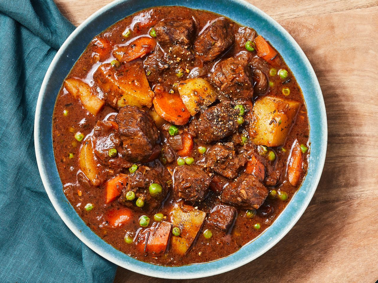 an overhead view looking into a single bowl of hearty beef stew.