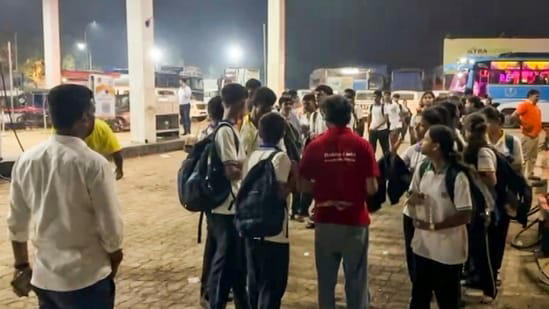 Stranded students wait at a petrol pump amid a traffic jam on the Mumbai-Ahmedabad National Highway at Vasai, in Palghar district, Maharashtra.