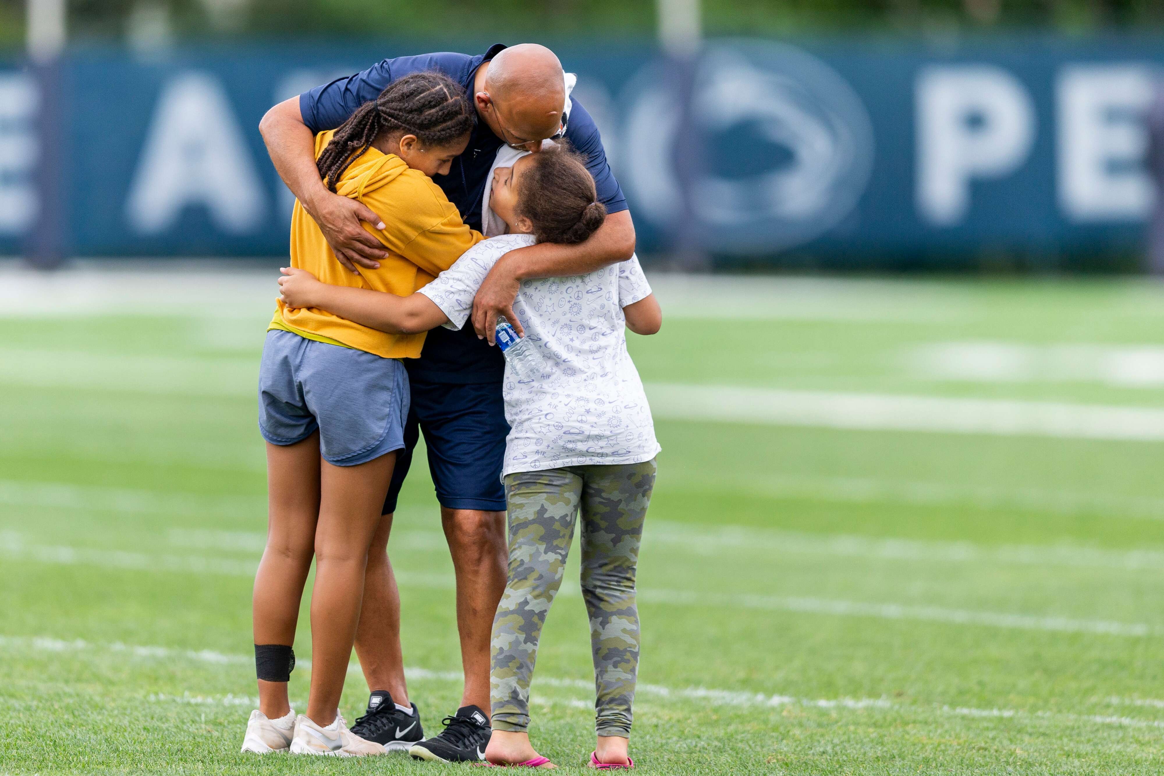 Penn State head coach James Franklin greets his daughter Shola and Addy after practice on Aug. 14, 2019. Joe Hermitt | jhermitt@pennlive.com